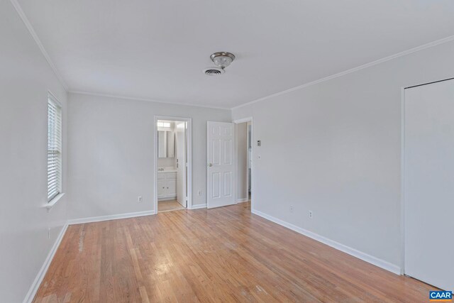 807 Watson Ave, Charlottesville, VA 22901 - unfurnished bedroom with crown molding, light wood-type flooring, baseboards, and ensuite bath