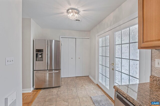 807 Watson Ave, Charlottesville, VA 22901 - kitchen with stainless steel fridge, baseboards, french doors, a chandelier, and dark stone countertops