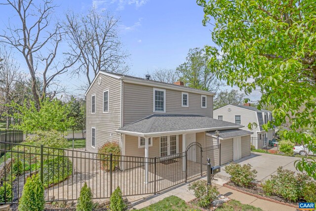 807 Watson Ave, Charlottesville, VA 22901 - view of front facade featuring concrete driveway, roof with shingles, a chimney, and an attached garage