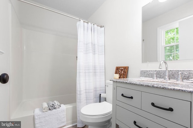 full bath featuring toilet, vanity, and shower / bathtub combination with curtain