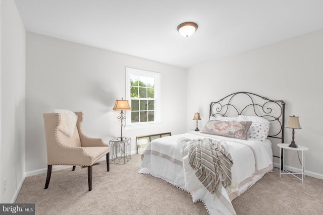 carpeted bedroom featuring baseboards