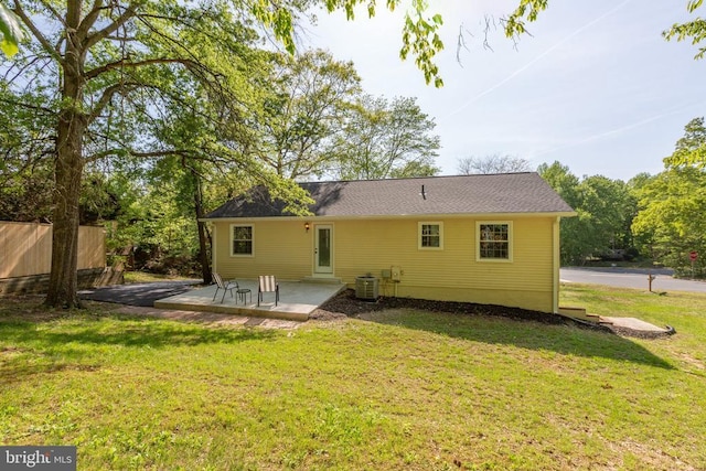 rear view of house with a patio and central AC
