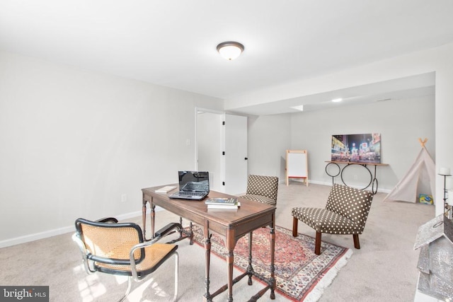 carpeted office featuring baseboards