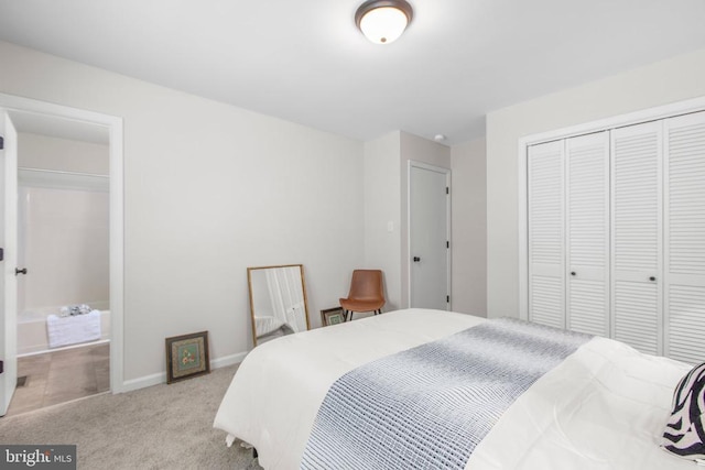 carpeted bedroom with a closet and baseboards