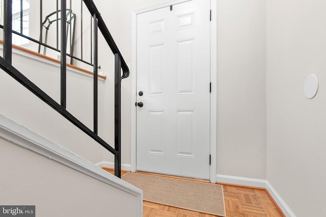 entryway with baseboards and stairs