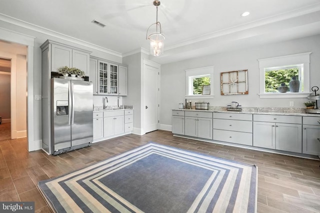 11109 Vanderbilt Cv, Spotsylvania, VA 22551 - kitchen featuring stainless steel fridge with ice dispenser, gray cabinets, glass insert cabinets, ornamental molding, and dark wood-style floors