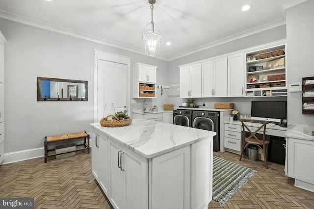 11109 Vanderbilt Cv, Spotsylvania, VA 22551 - kitchen with washer and dryer, open shelves, white cabinetry, built in desk, and a center island