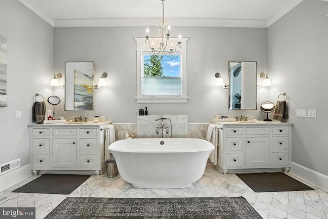 11109 Vanderbilt Cv, Spotsylvania, VA 22551 - full bathroom featuring marble finish floors, a chandelier, a soaking tub, two vanities, and ornamental molding