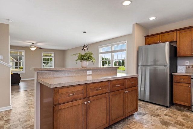43 Upland Ct, Stuarts Draft, VA 24477 - kitchen with freestanding refrigerator, brown cabinets, light countertops, a ceiling fan, and recessed lighting