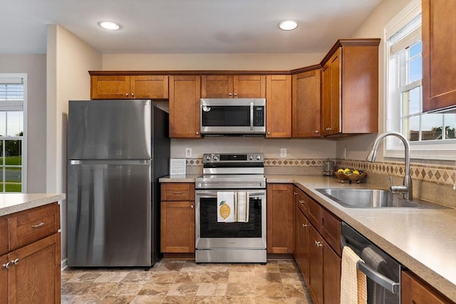 43 Upland Ct, Stuarts Draft, VA 24477 - kitchen featuring appliances with stainless steel finishes, brown cabinetry, healthy amount of natural light, light countertops, and recessed lighting