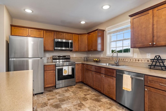 43 Upland Ct, Stuarts Draft, VA 24477 - kitchen with stainless steel appliances, light countertops, brown cabinetry, recessed lighting, and stone finish flooring