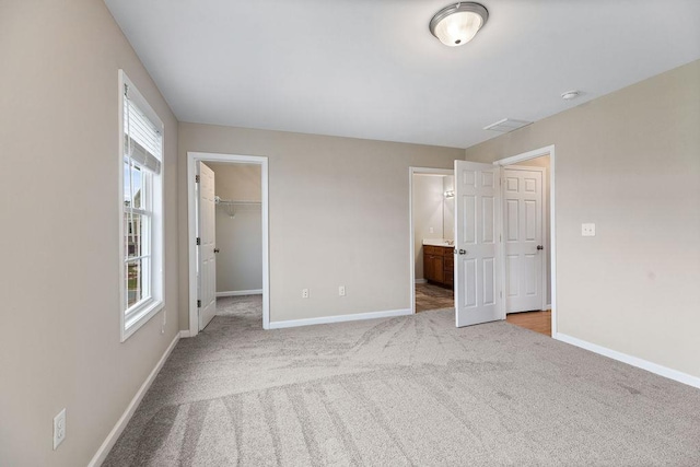 43 Upland Ct, Stuarts Draft, VA 24477 - unfurnished bedroom with a spacious closet, light colored carpet, and ensuite bathroom