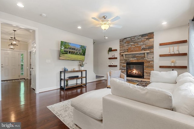 living area featuring dark wood-type flooring, ceiling fan, recessed lighting, baseboards, and a fireplace
