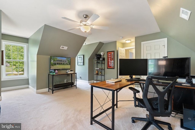 carpeted office featuring baseboards, vaulted ceiling, and a ceiling fan