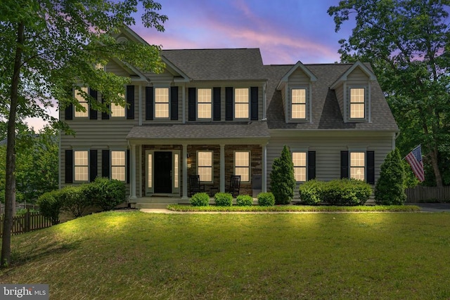 view of front of property with covered porch and roof with shingles