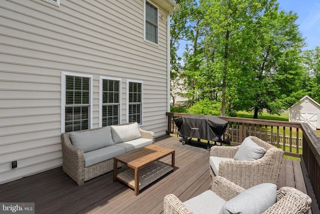deck with an outdoor hangout area, a shed, and an outdoor structure