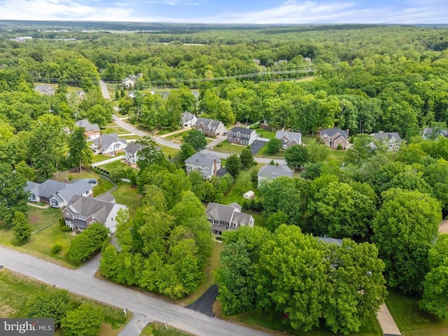 aerial view of residential area featuring a heavily wooded area