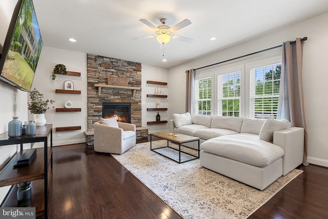 living room featuring ceiling fan, wood finished floors, baseboards, recessed lighting, and a fireplace
