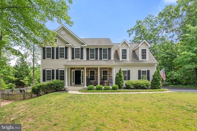 view of front of home with covered porch and roof with shingles