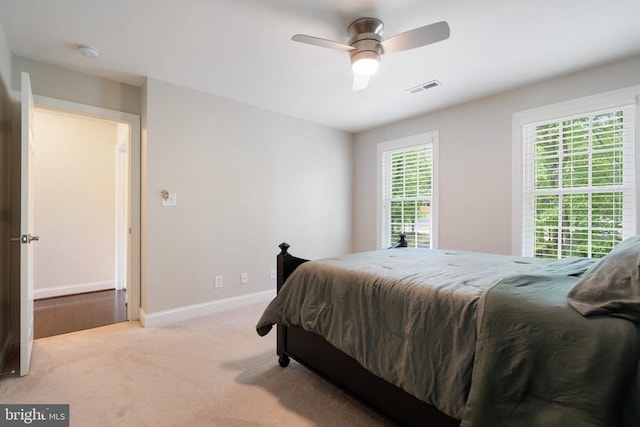 bedroom with baseboards, carpet flooring, and a ceiling fan
