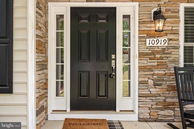 view of exterior entry featuring stone siding
