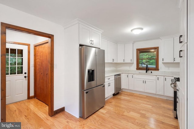 15395 Rillhurst Dr, Culpeper, VA 22701 - kitchen featuring appliances with stainless steel finishes, a sink, light wood-style floors, white cabinets, and baseboards