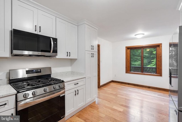 15395 Rillhurst Dr, Culpeper, VA 22701 - kitchen with appliances with stainless steel finishes, light wood-style floors, baseboards, white cabinetry, and light stone counters