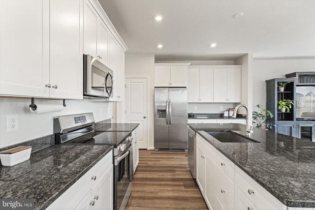 6520 Wild Orchid Ct, Fredericksburg, VA 22407 - kitchen with appliances with stainless steel finishes, a sink, dark wood finished floors, white cabinetry, and a kitchen island with sink