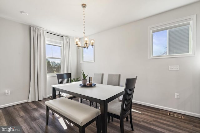 6520 Wild Orchid Ct, Fredericksburg, VA 22407 - dining room with a chandelier, dark wood finished floors, and baseboards