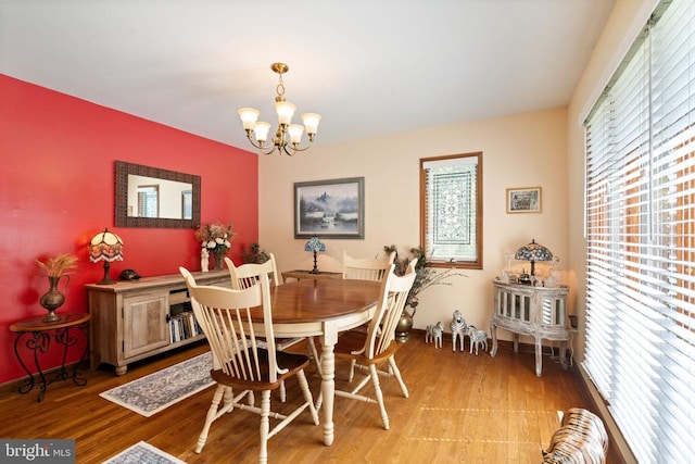 dining area featuring a chandelier and light wood-type flooring