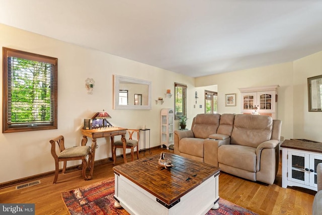 living room with wood finished floors and baseboards