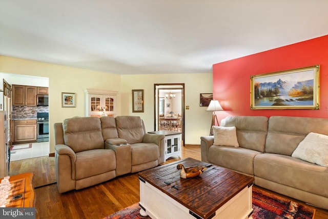 living room featuring wood finished floors and a chandelier