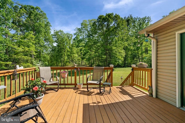 wooden terrace with a yard