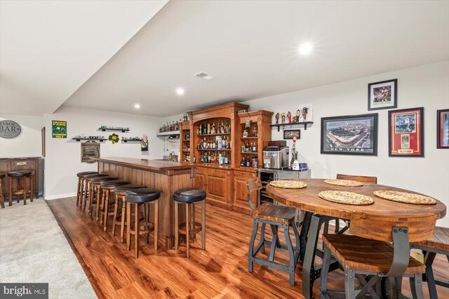11326 Oakville Ln, Spotsylvania, VA 22551 - indoor wet bar with wine cooler, recessed lighting, light wood-style flooring, and light carpet