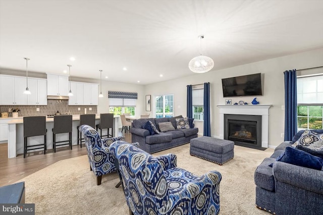 11326 Oakville Ln, Spotsylvania, VA 22551 - living area featuring plenty of natural light, light wood finished floors, a fireplace with flush hearth, and recessed lighting