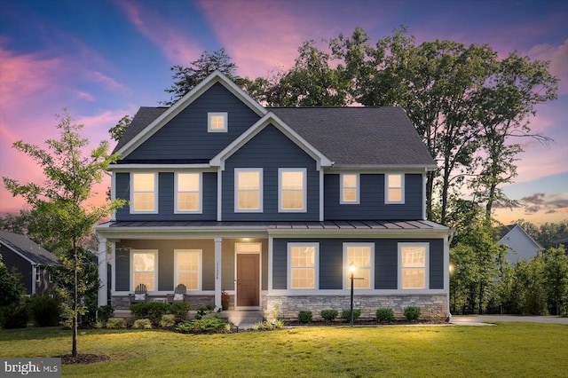 11326 Oakville Ln, Spotsylvania, VA 22551 - view of front of house featuring a porch, a standing seam roof, a lawn, stone siding, and a metal roof