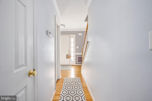 10501 Crestfield Ln, Spotsylvania, VA 22553 - hall with light wood-style flooring, ornamental molding, stairway, and baseboards