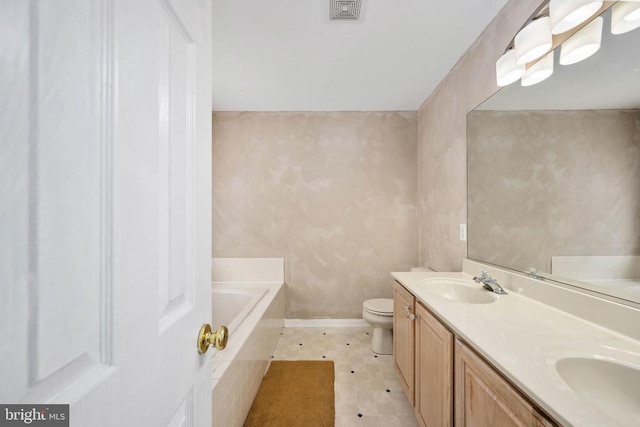 10501 Crestfield Ln, Spotsylvania, VA 22553 - bathroom featuring a garden tub, toilet, double vanity, and baseboards