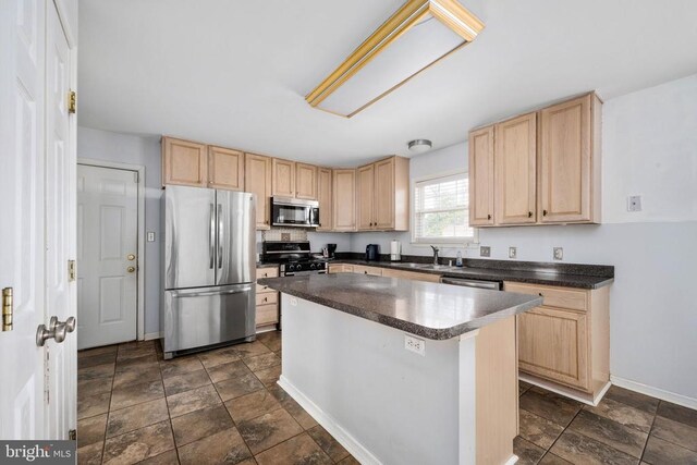 10501 Crestfield Ln, Spotsylvania, VA 22553 - kitchen with stainless steel appliances, light brown cabinetry, dark stone finish flooring, dark countertops, and a center island