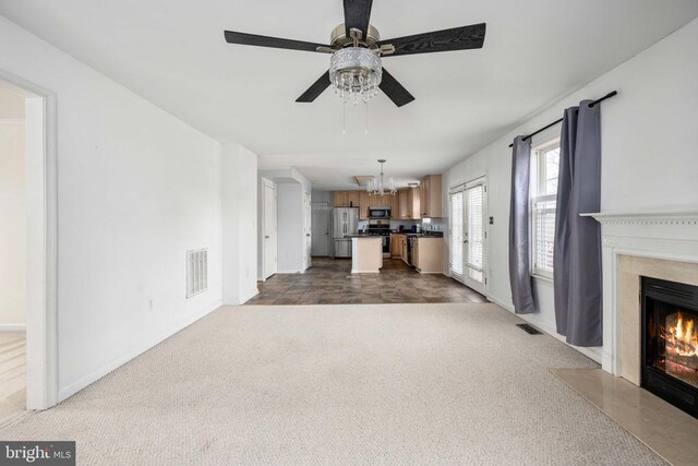 10501 Crestfield Ln, Spotsylvania, VA 22553 - unfurnished living room with a premium fireplace, a chandelier, a ceiling fan, dark carpet, and baseboards
