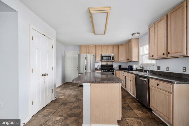 10501 Crestfield Ln, Spotsylvania, VA 22553 - kitchen featuring appliances with stainless steel finishes, light brown cabinetry, a sink, dark countertops, and stone finish flooring