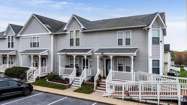 1294 Victorian Village Dr, Harrisonburg, VA 22802 - townhome / multi-family property with a shingled roof, uncovered parking, and a porch
