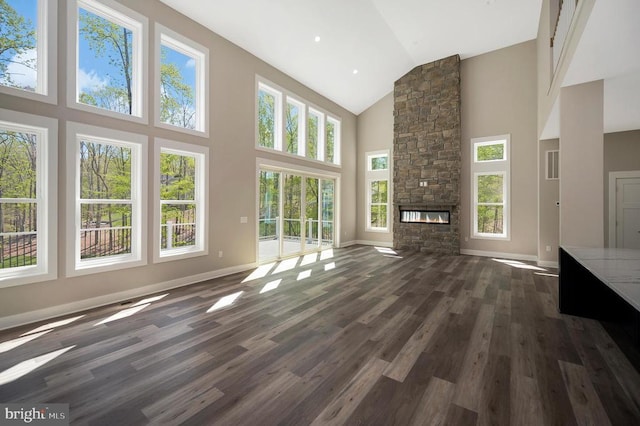 44 Deep Creek Cir, Bumpass, VA 23024 - unfurnished living room featuring high vaulted ceiling, a fireplace, and dark wood-style floors