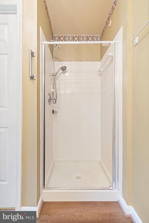 4117 Dartmoor Ct, Fredericksburg, VA 22408 - full bathroom featuring a stall shower, wood finished floors, and baseboards