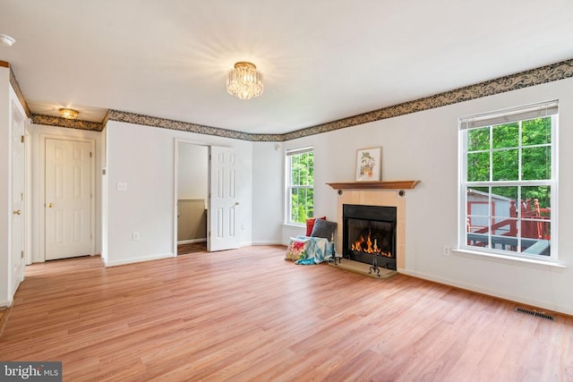 4117 Dartmoor Ct, Fredericksburg, VA 22408 - unfurnished living room with light wood-style floors, a tile fireplace, and baseboards