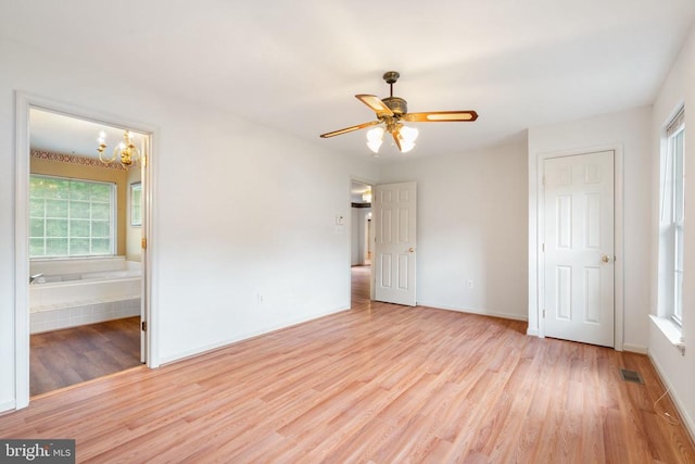 4117 Dartmoor Ct, Fredericksburg, VA 22408 - unfurnished bedroom with multiple windows, light wood-style flooring, a chandelier, and baseboards