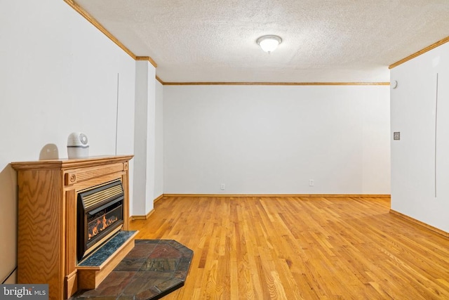 4117 Dartmoor Ct, Fredericksburg, VA 22408 - unfurnished living room with crown molding, a textured ceiling, wood finished floors, a glass covered fireplace, and baseboards