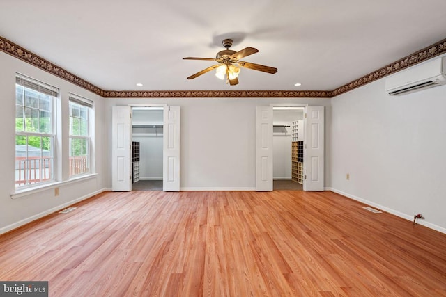 4117 Dartmoor Ct, Fredericksburg, VA 22408 - unfurnished bedroom with a wall mounted air conditioner, baseboards, light wood-style floors, multiple closets, and recessed lighting