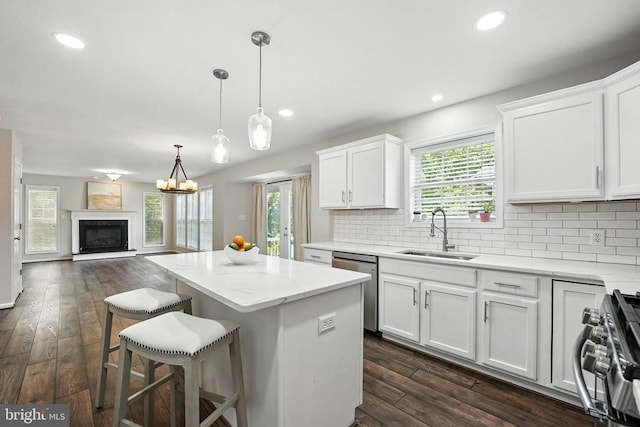 6205 Patrician Ct, Fredericksburg, VA 22407 - kitchen featuring appliances with stainless steel finishes, a kitchen island, backsplash, white cabinetry, and open floor plan