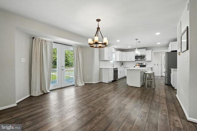 6205 Patrician Ct, Fredericksburg, VA 22407 - kitchen with stainless steel appliances, french doors, a center island, dark wood-type flooring, and backsplash